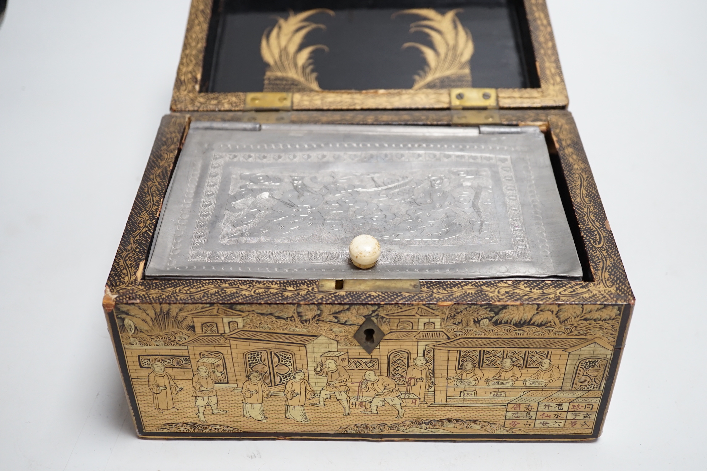 A 19th century Chinese export lacquer tea caddy, black ground with gilt decoration, containing a separate lidded pewter lining box with engraved decoration, 23cm x 16cm x 12cm